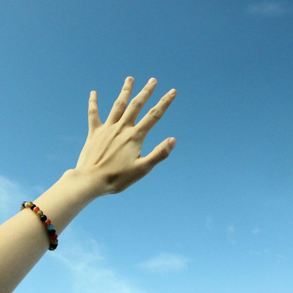 Person feeling energized and stretching towards the sky.
